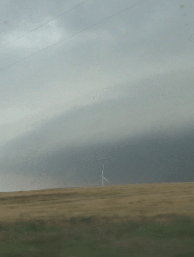 Lots of energy coming out of the El Reno supercell. Video capture from the south looking across wind farm near Union City