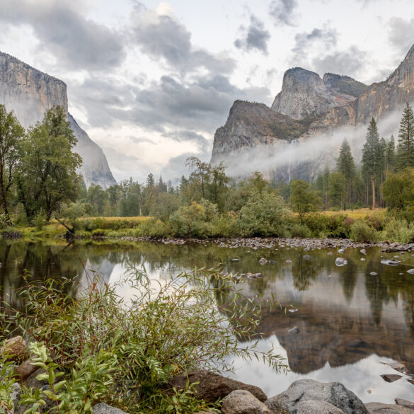 A dramatic scene in the Yosemite Valley as rain showers leave fog